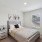 Furnished bedroom with a large window inside a rental home at Canvas on Founders Hill