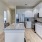 Open concept floor plan with kitchen island and stainless steel appliances inside a home at Canvas on Founders Hill