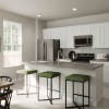 Large well lit kitchen with wood floors 